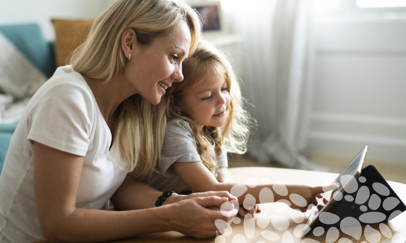 mom and daughter looking at computer
